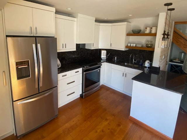 kitchen with appliances with stainless steel finishes, a sink, open shelves, white cabinetry, and recessed lighting
