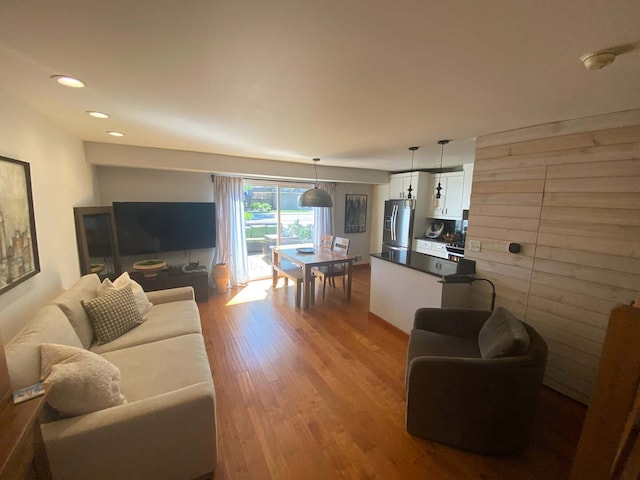 living area featuring wood finished floors and recessed lighting
