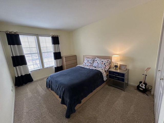 carpeted bedroom featuring baseboards