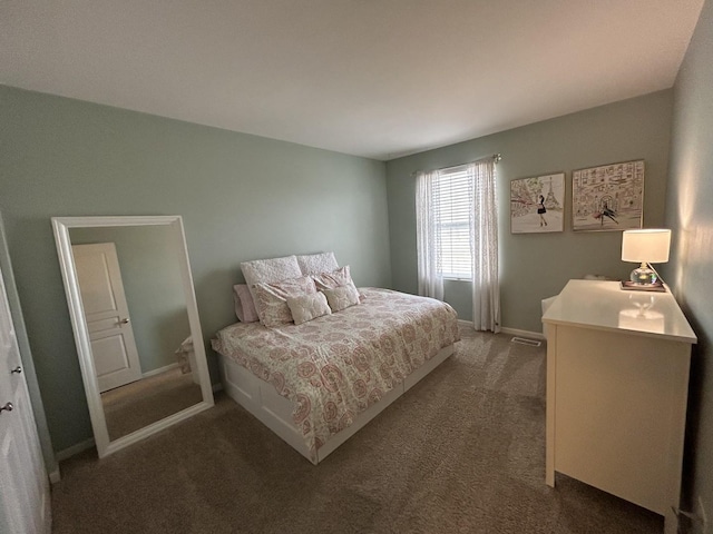 bedroom with baseboards and carpet