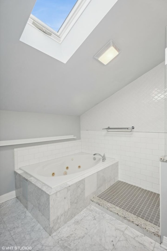 3755 N Wilton Ave Unit 3Se, Chicago, IL 60613 - bathroom with vaulted ceiling with skylight, a whirlpool tub, and marble finish floor