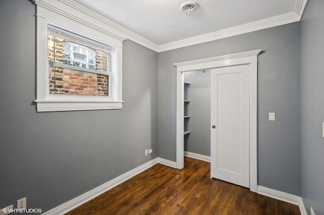 3755 N Wilton Ave Unit 3Se, Chicago, IL 60613 - unfurnished bedroom featuring crown molding, visible vents, a closet, baseboards, and dark wood-type flooring