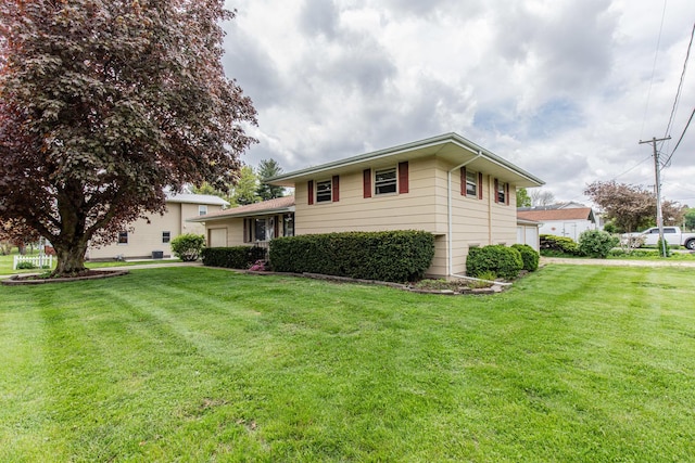 tri-level home with a front lawn