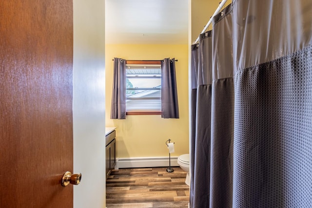 bathroom featuring baseboard heating, wood finished floors, baseboards, toilet, and a shower with shower curtain