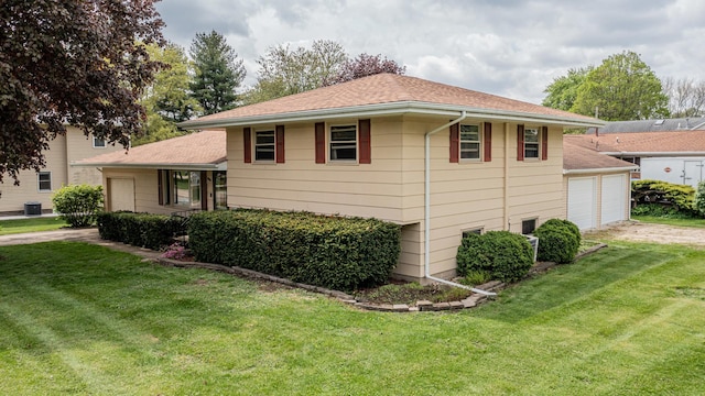 view of home's exterior with a lawn and a shingled roof