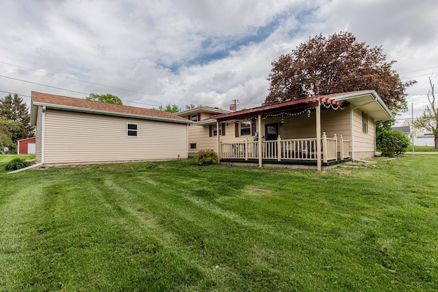 rear view of house featuring a lawn