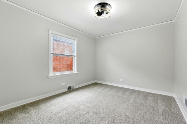 unfurnished room with crown molding, baseboards, visible vents, and carpet flooring