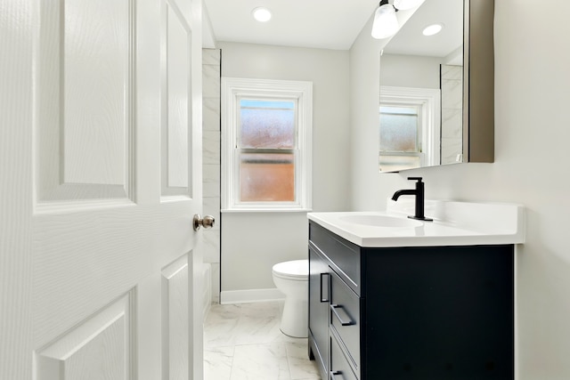 full bath with vanity, marble finish floor, baseboards, and toilet