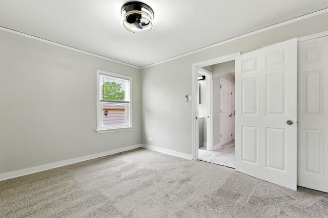 unfurnished bedroom with carpet floors, baseboards, and ornamental molding