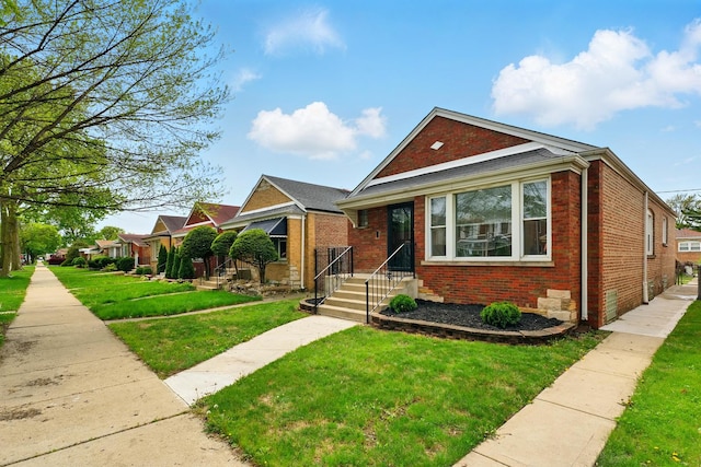 bungalow with brick siding and a front yard