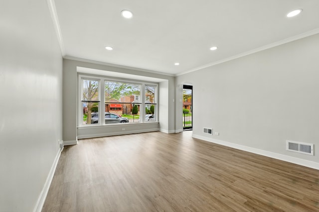 unfurnished room with crown molding, baseboards, and visible vents