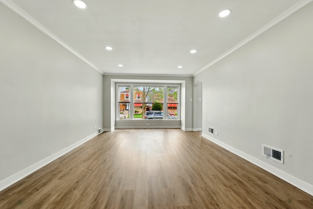 unfurnished living room with crown molding, recessed lighting, and visible vents