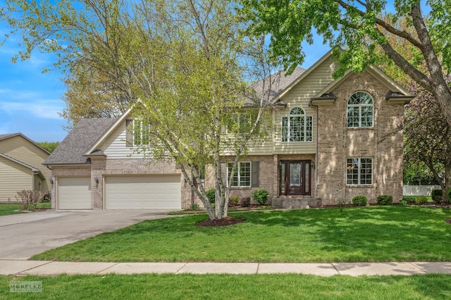 view of front of property with brick siding, an attached garage, a front yard, and concrete driveway