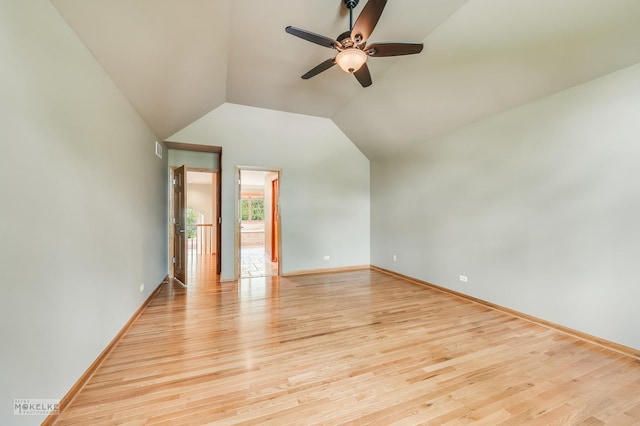 unfurnished room featuring visible vents, baseboards, light wood-type flooring, a ceiling fan, and vaulted ceiling