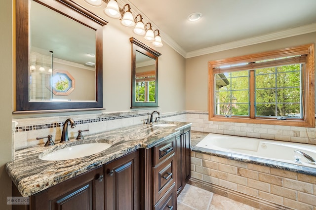 full bathroom featuring double vanity, ornamental molding, a sink, and a garden tub