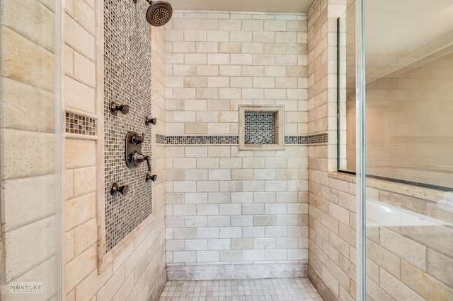 full bath with a tile shower