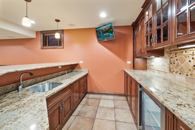 bar featuring a sink, wine cooler, backsplash, pendant lighting, and a bar