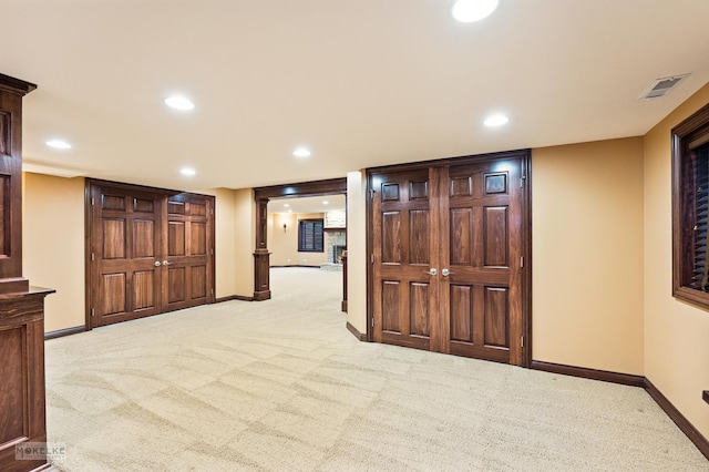 empty room with light colored carpet, recessed lighting, baseboards, and visible vents
