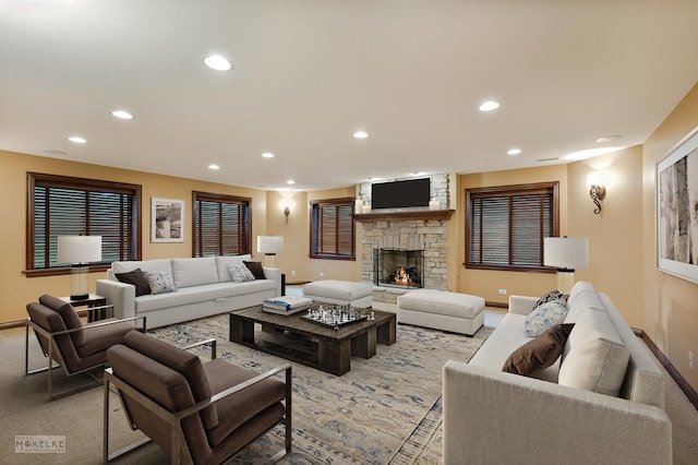 living area with baseboards, recessed lighting, a fireplace, and light colored carpet