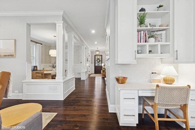 311 E Schiller St, Elmhurst, IL 60126 - bar area with dark wood-type flooring, plenty of natural light, ornate columns, tasteful backsplash, and crown molding