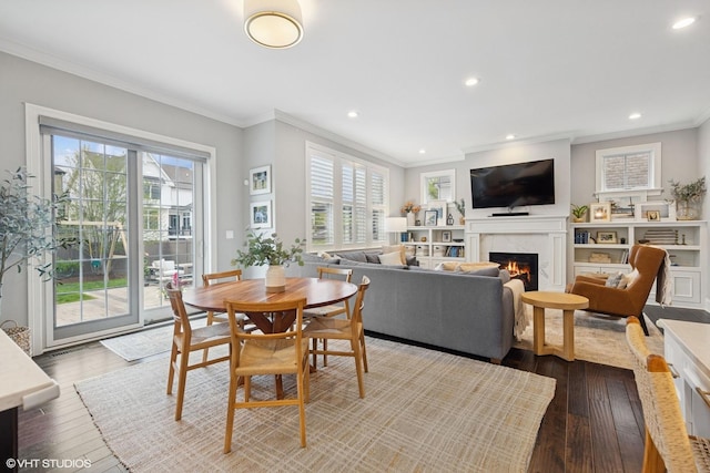 311 E Schiller St, Elmhurst, IL 60126 - dining space with ornamental molding, dark wood-type flooring, healthy amount of natural light, a premium fireplace, and recessed lighting