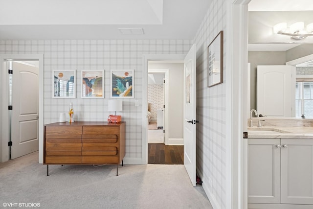311 E Schiller St, Elmhurst, IL 60126 - bedroom featuring wallpapered walls, a sink, carpet floors, and baseboards