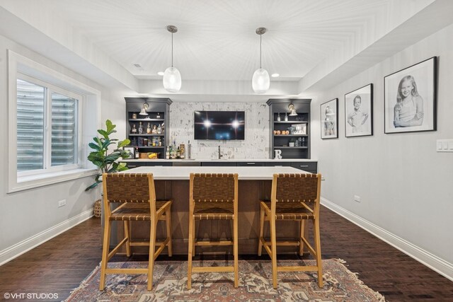 311 E Schiller St, Elmhurst, IL 60126 - indoor wet bar featuring dark wood finished floors, baseboards, and pendant lighting