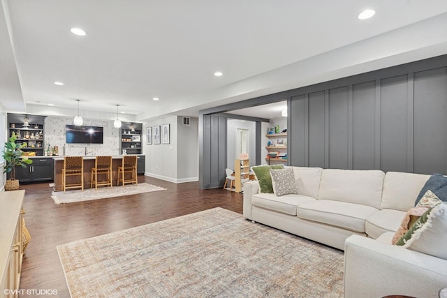 311 E Schiller St, Elmhurst, IL 60126 - living area with bar with sink, recessed lighting, dark wood-style flooring, and baseboards