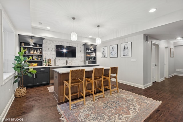 311 E Schiller St, Elmhurst, IL 60126 - indoor wet bar featuring dishwasher, baseboards, dark wood-style flooring, hanging light fixtures, and recessed lighting