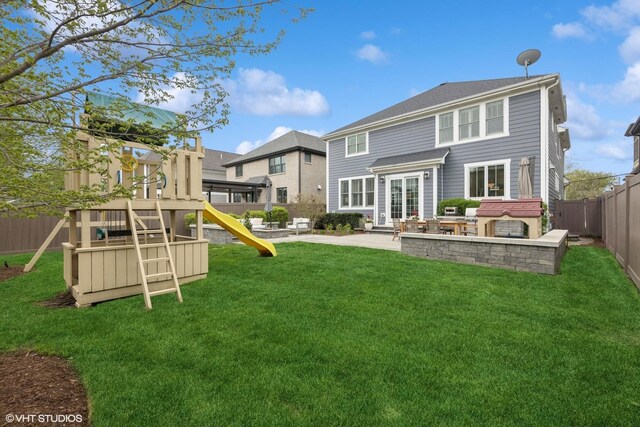 311 E Schiller St, Elmhurst, IL 60126 - rear view of house with a playground and a patio