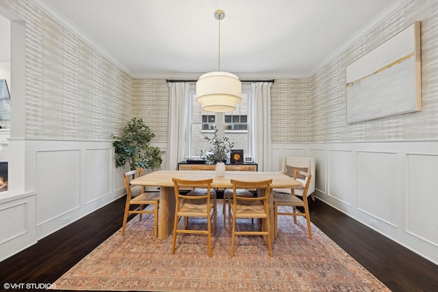 311 E Schiller St, Elmhurst, IL 60126 - dining room with dark wood finished floors, a decorative wall, wallpapered walls, a wainscoted wall, and a lit fireplace