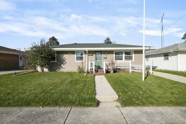ranch-style house with a front lawn and covered porch