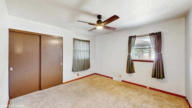 2818 Brentwood Dr, Racine, WI 53403 - unfurnished bedroom with carpet floors, a closet, baseboards, and a ceiling fan
