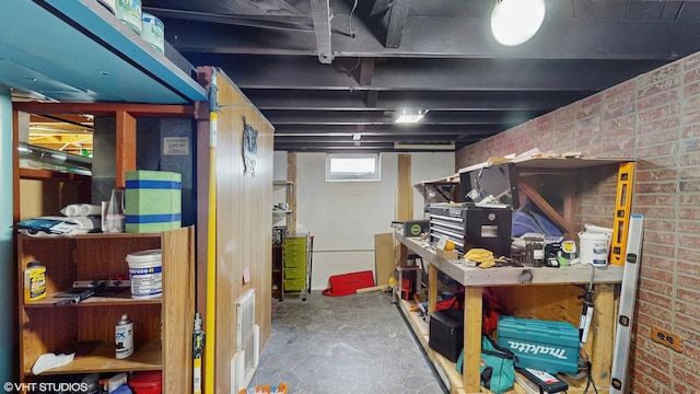 2818 Brentwood Dr, Racine, WI 53403 - basement featuring a workshop area and brick wall