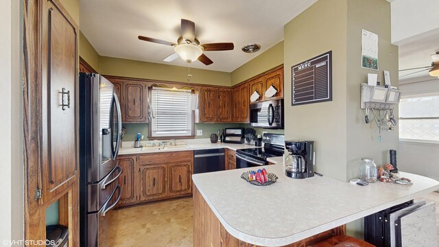 2818 Brentwood Dr, Racine, WI 53403 - kitchen with appliances with stainless steel finishes, ceiling fan, a peninsula, and a sink