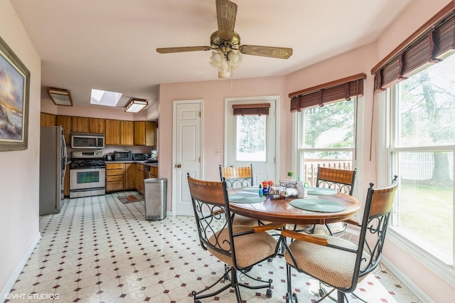 325 Olin Ct, Algonquin, IL 60102 - dining area featuring baseboards, a skylight, light floors, and ceiling fan