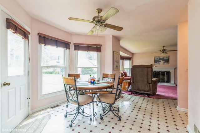 325 Olin Ct, Algonquin, IL 60102 - dining area with ceiling fan, baseboards, tile patterned floors, and a fireplace with raised hearth