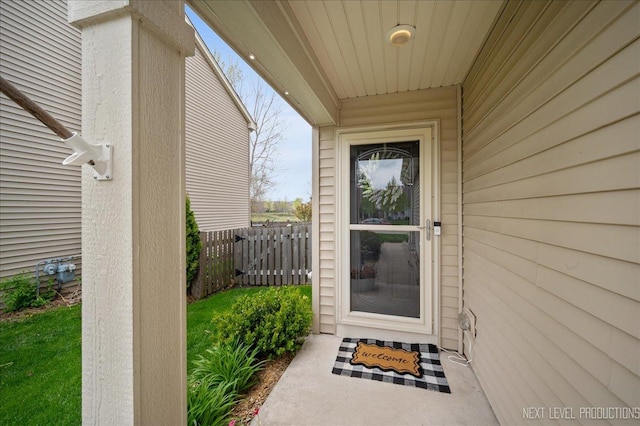 view of exterior entry with fence