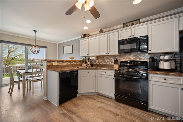kitchen featuring black appliances, a peninsula, tasteful backsplash, ornamental molding, and a ceiling fan