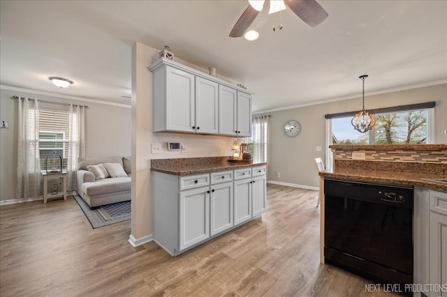 kitchen with black dishwasher, crown molding, baseboards, dark countertops, and light wood-style flooring