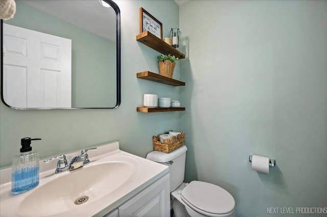 bathroom featuring toilet and vanity