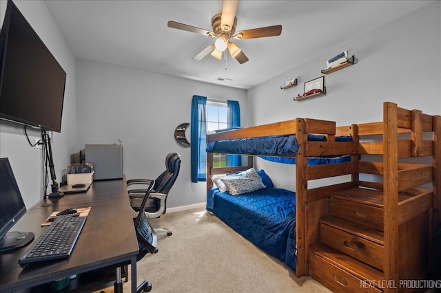 bedroom featuring carpet floors, a desk, baseboards, and a ceiling fan