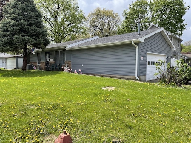 exterior space featuring a lawn, central AC unit, and a garage