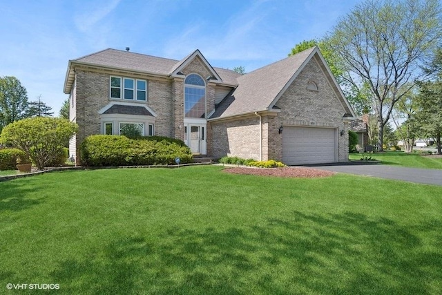 view of front of house with driveway, a garage, brick siding, and a front yard