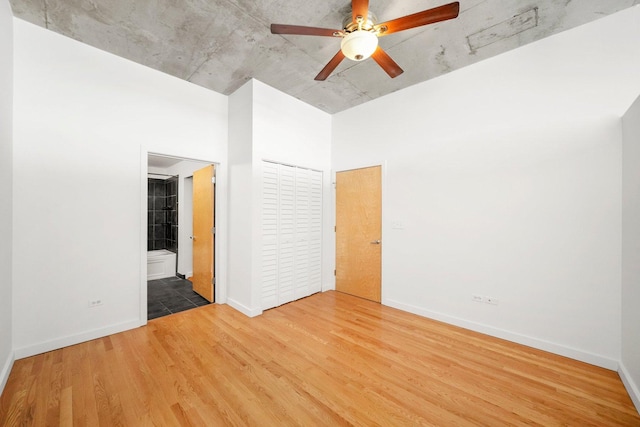 1720 S Michigan Ave Unit 2113, Chicago, IL 60616 - unfurnished bedroom featuring wood finished floors, ensuite bathroom, and a ceiling fan
