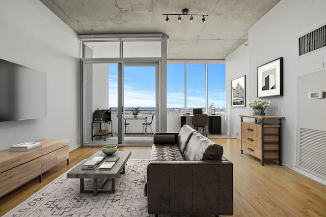 1720 S Michigan Ave Unit 2113, Chicago, IL 60616 - living area with wood finished floors, expansive windows, and rail lighting