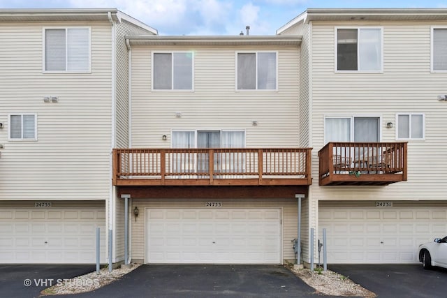 24733 Patriot Square Dr S, Plainfield, IL 60544 - back of house featuring a garage, driveway, and a balcony