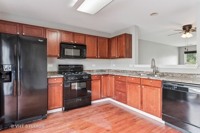 24733 Patriot Square Dr S, Plainfield, IL 60544 - kitchen featuring black appliances, a sink, light wood-style flooring, a ceiling fan, and brown cabinetry