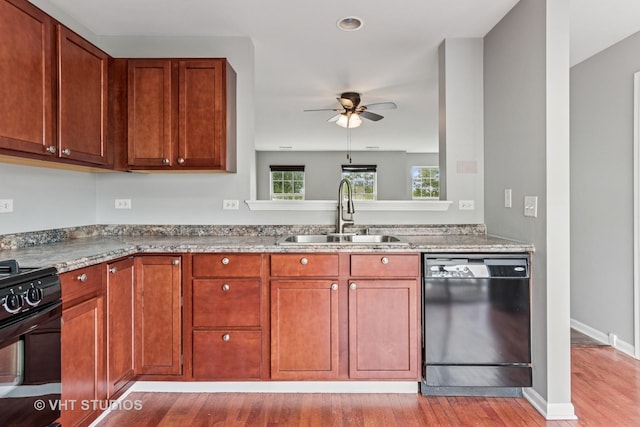 24733 Patriot Square Dr S, Plainfield, IL 60544 - kitchen with black appliances, a sink, ceiling fan, wood finished floors, and light stone countertops