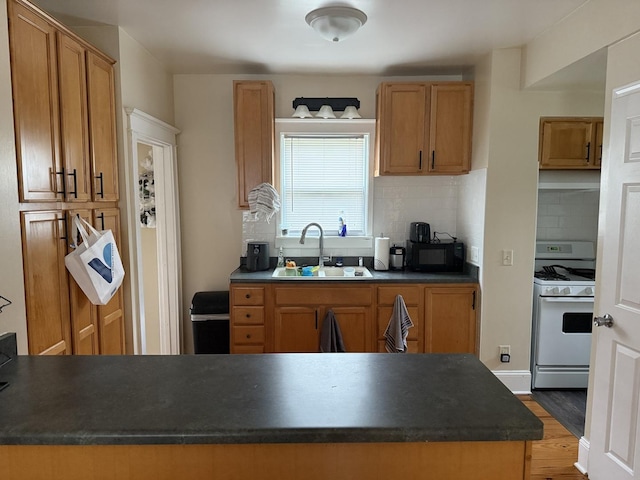 160 S Fordham Ave, Aurora, IL 60506 - kitchen featuring gas range gas stove, dark countertops, and tasteful backsplash